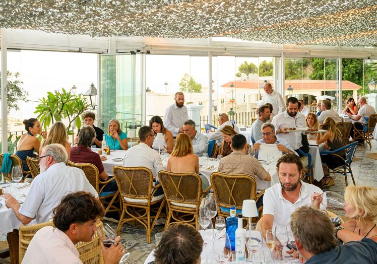 Diners enjoying the Tuna event at Escorpio Restaurant with magnificent views to the sea.