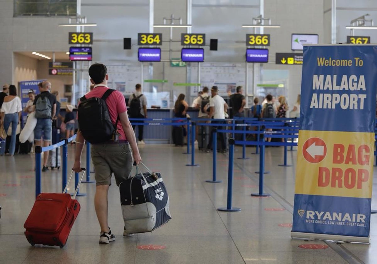 Traveller heading for the Ryanair check-in desks at Malaga Airport.