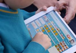 Child with tablet.