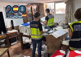 National Police officers carry out a search in the house where he was arrested.