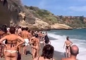 Picture of bathers watching the lifeguards at Burriana beach in Nerja.