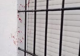 Traces of blood on the wall of a house in the street where the incident happened.